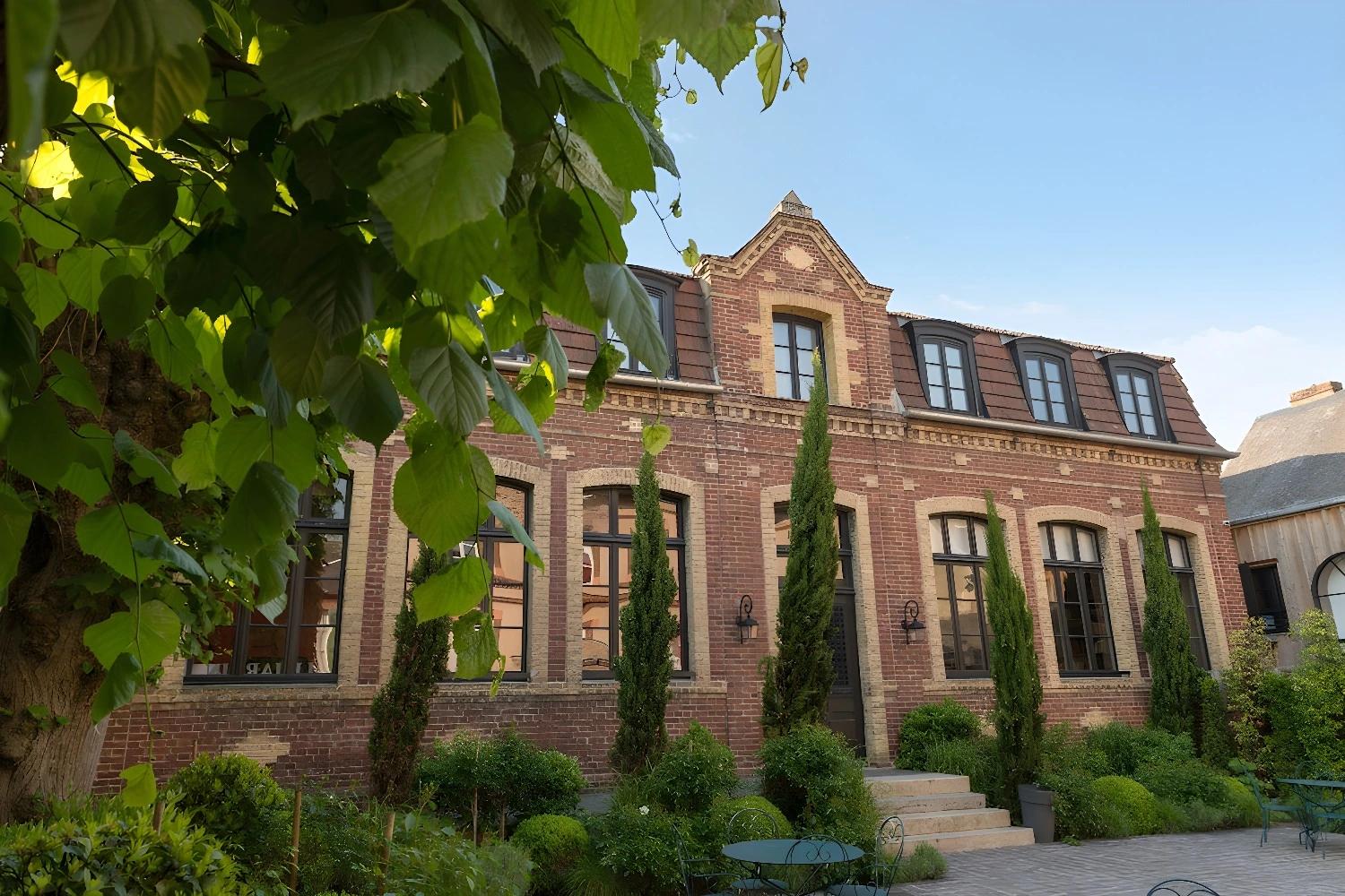 Façade extérieure des Maisons de Léa entourée de verdure