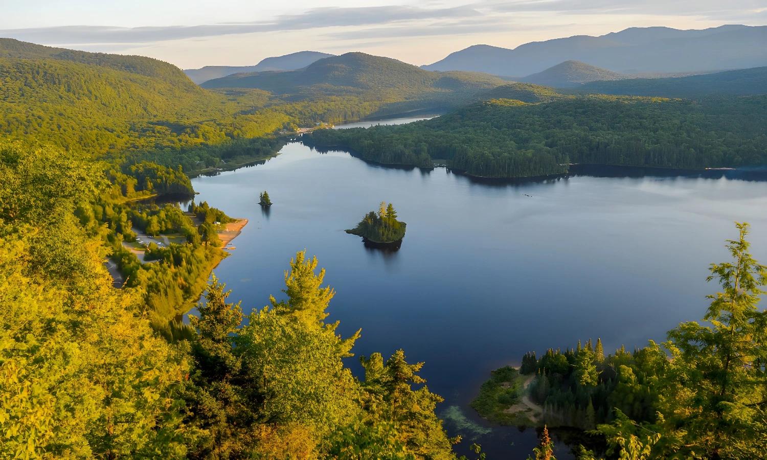 Vue panoramique d'un lac entouré de montagnes au Québec sur la route des explorateurs