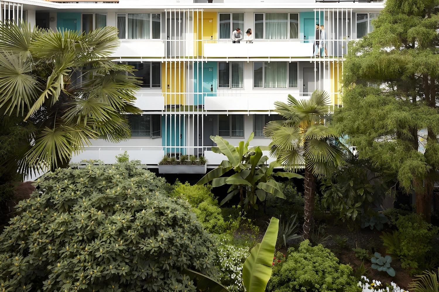 Vue extérieure de l'hôtel The Burrard avec jardin luxuriant.